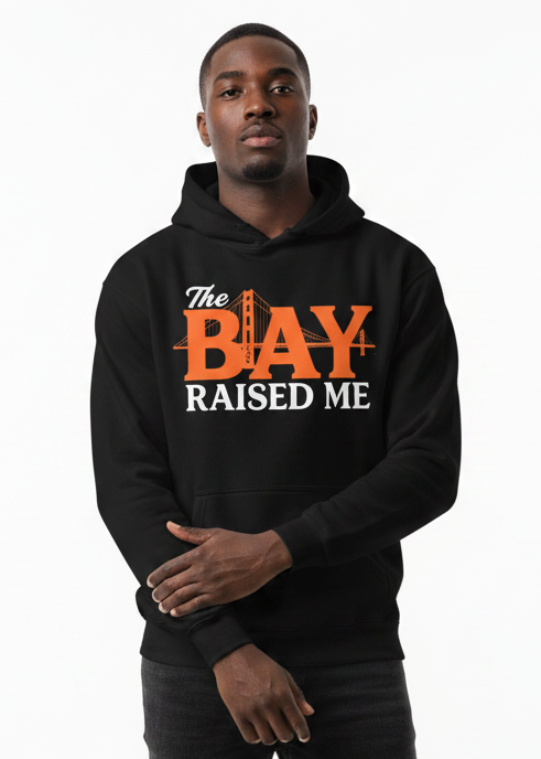 Person wearing a black hoodie with 'The Bay Raised Me' text on a white background