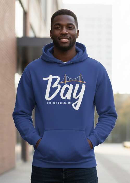 Man wearing a blue hoodie with 'Bay' printed on it, standing outdoors.