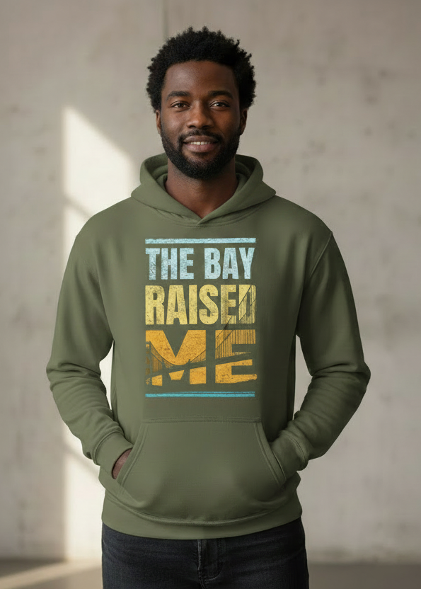 Person wearing a green hoodie with text, standing in a softly lit room.